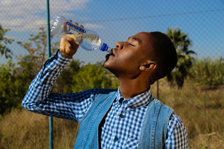 a man drinking water out of a plastic bottle, pexels contest winner, renaissance, african aaron paul, avatar image, male teenager, ad image
