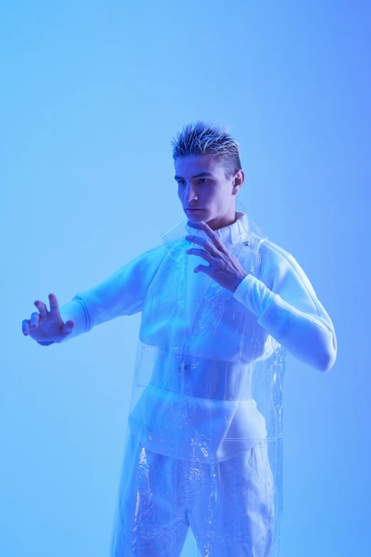a male in a white shirt and white pants, an album cover, inspired by Kristian Kreković, trending on pexels, holography, rubber undersuit, blue skintight closed longcoat, covered in circuitry, julian ope