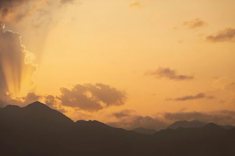 there is a plane that is flying in the sky, by Carey Morris, unsplash, minimalism, mountain sunrise, brown, sunset kanagawa prefecture, shades of gold display naturally