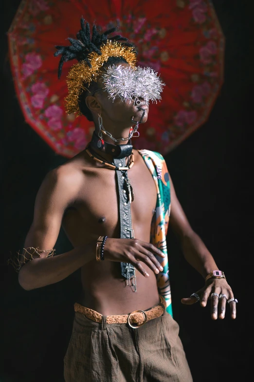 a man standing in front of a red umbrella, an album cover, inspired by Afewerk Tekle, trending on pexels, afrofuturism, beads cross onbare chest, wearing loincloth, with a mohawk, model posing