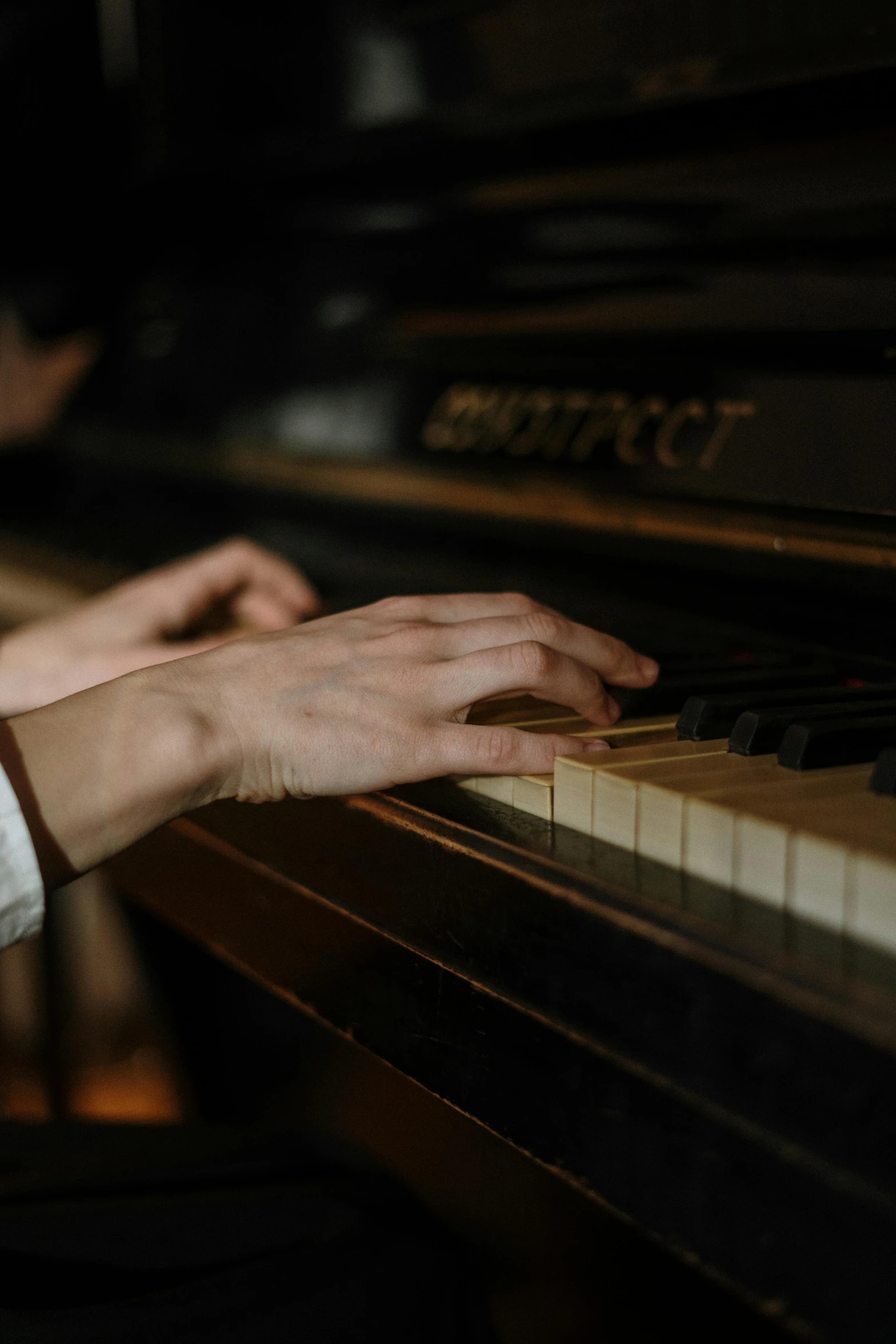 a close up of a person playing a piano