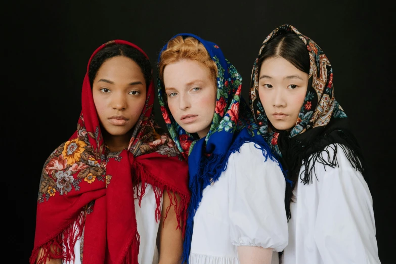 a group of three women standing next to each other, inspired by Jean-Étienne Liotard, trending on unsplash, red scarf, ukrainian girl, junya watanabe, press shot