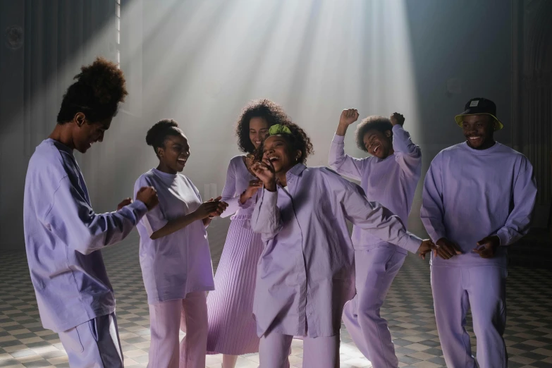 a group of people standing on top of a checkered floor, pexels contest winner, black arts movement, purple robes, other women dancing behind, bathed in light, prison scene