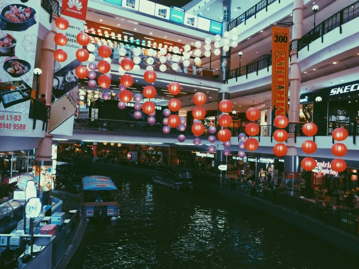 a city filled with lots of shops next to a river, inspired by Miyagawa Chōshun, pexels contest winner, red lanterns, food court in a mall, shot with iphone 1 0, fujicolor with flash