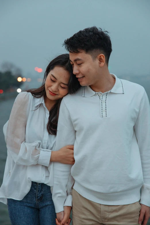 a man and a woman standing next to each other, by Tan Ting-pho, pexels contest winner, happening, wearing a white sweater, romantic themed, wearing polo shirt, bao phan