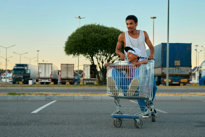 a man pushing a shopping cart down a street, by Dan Luvisi, pexels contest winner, hyperrealism, medium shot of two characters, outside in parking lot, avatar image, actor
