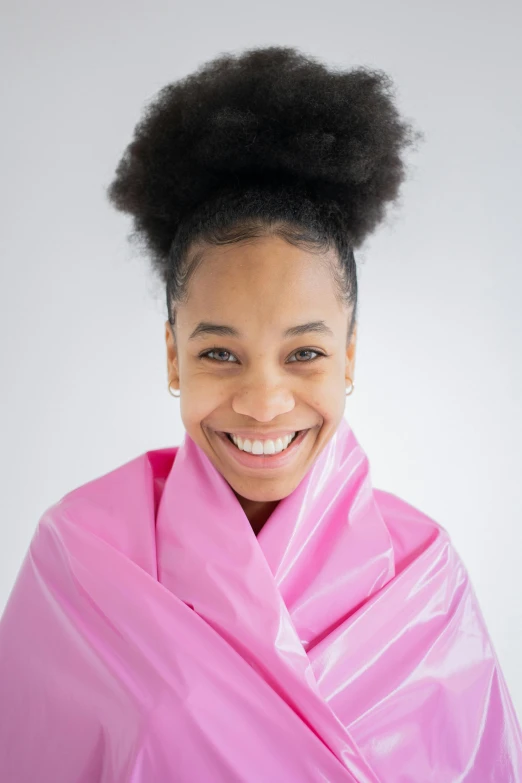 a smiling woman wrapped in a pink blanket, by Dulah Marie Evans, shutterstock contest winner, latex suit and raincoat, natural hair, black teenage girl, close - up studio photo