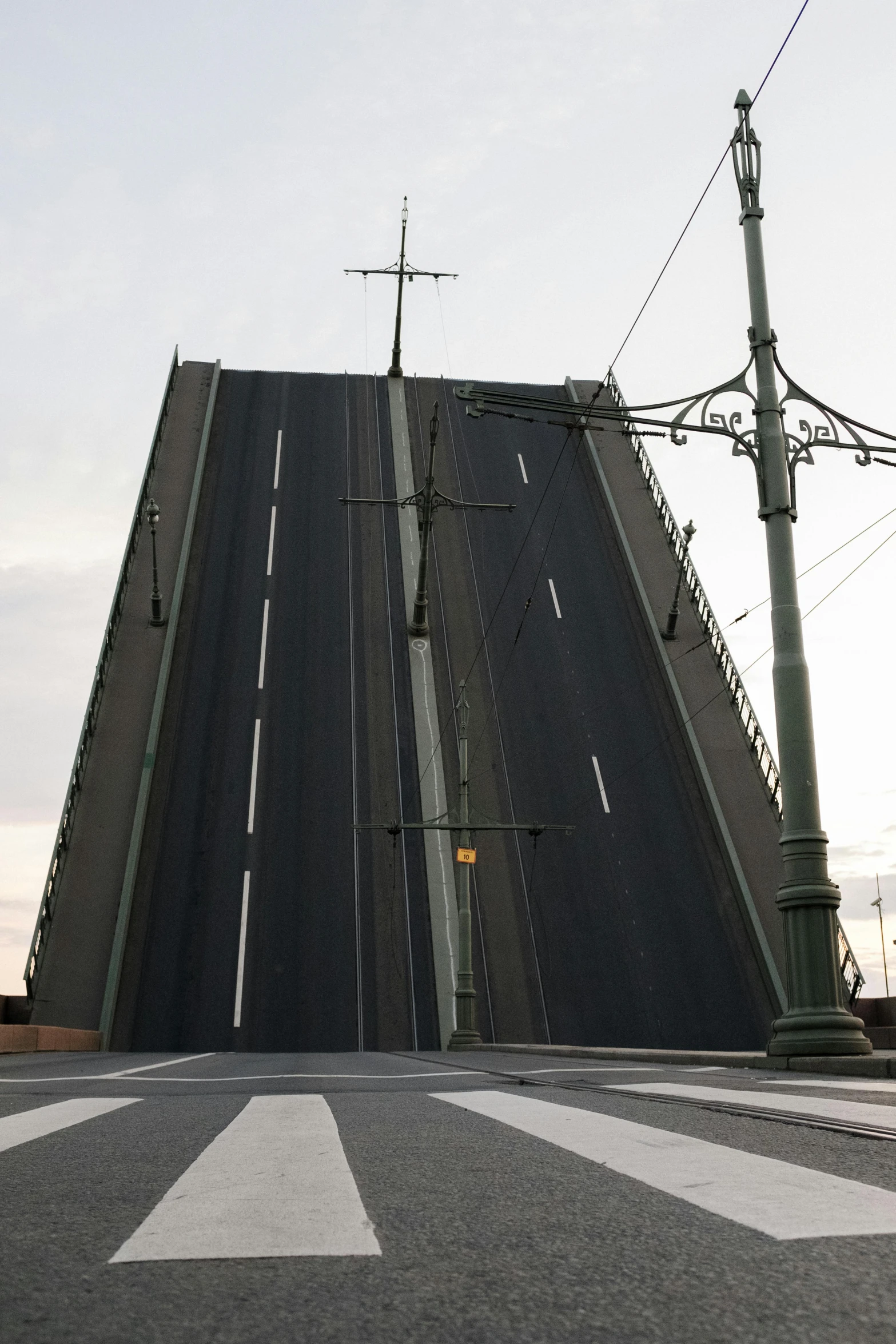 a man riding a skateboard down a street next to a bridge, huge level structure, finland, 000 — википедия, highly accurate