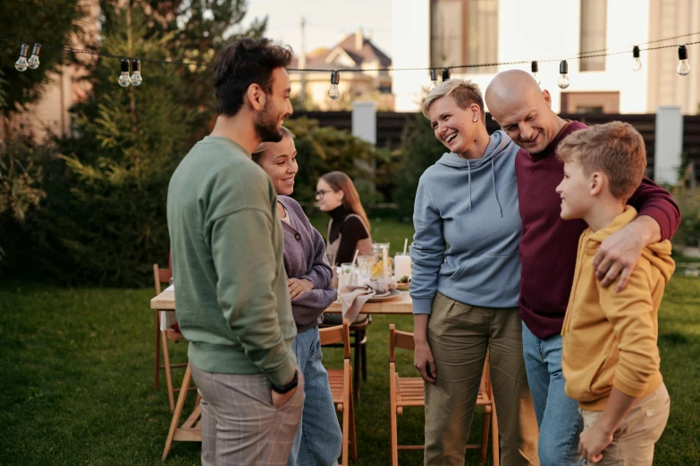 a group of people standing around a table, a portrait, by Carey Morris, shutterstock, in a suburban backyard, people enjoying the show, instagram post, men and women
