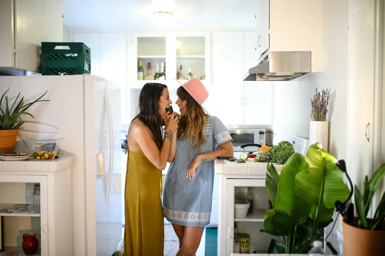 a couple of women standing next to each other in a kitchen, pexels contest winner, happening, lush greens, licking tongue, sydney hanson, hippie pad