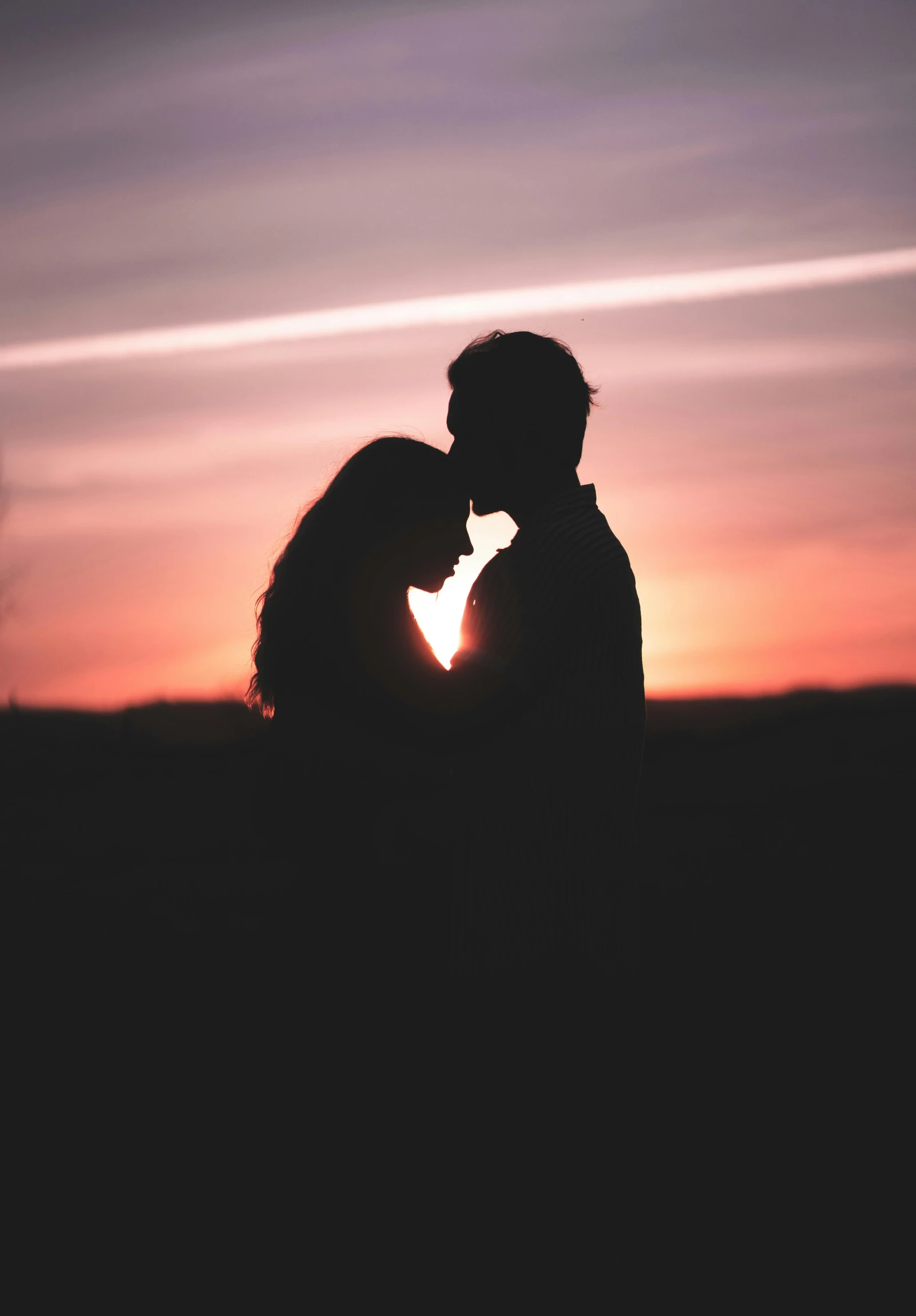 a man and a woman kissing in front of a sunset, pexels, profile image, large)}], blank, february)