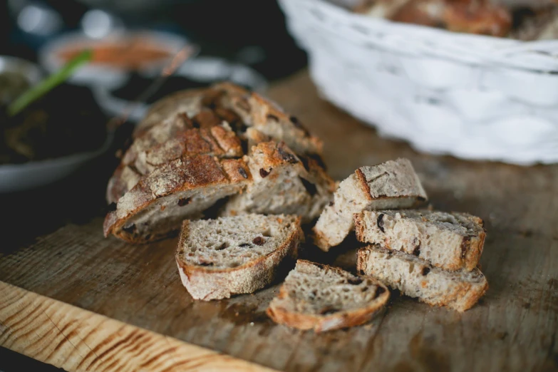 a loaf of bread sitting on top of a wooden cutting board, by Daniel Lieske, pexels, figuration libre, sliced bread in slots, “ iron bark, food. craft and adventure, recipe