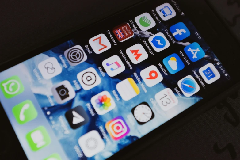 a close up of a cell phone on a table, pexels, app icon, square, multicoloured, ios