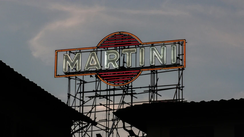 a large neon sign on top of a building, by Ndoc Martini, fausto de martini, fan favorite, martine, morandi