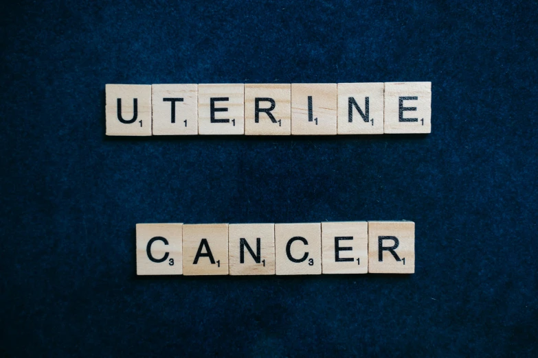 a couple of scrabbles that say utterine and cancer, a portrait, by Julia Pishtar, shutterstock, uppercase letter, octane ue 5, high quality upload, litter