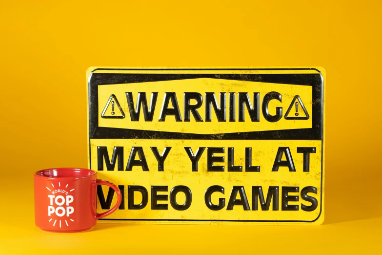 a red mug sitting next to a warning sign, pexels, pop art, gamer screen on metallic desk, yelow, totally mad and yelling, stop motion vinyl figure