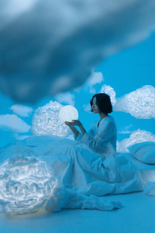 a woman sitting on a cloud covered ground, brightly lit blue room, translucent orbs, white sky, reading