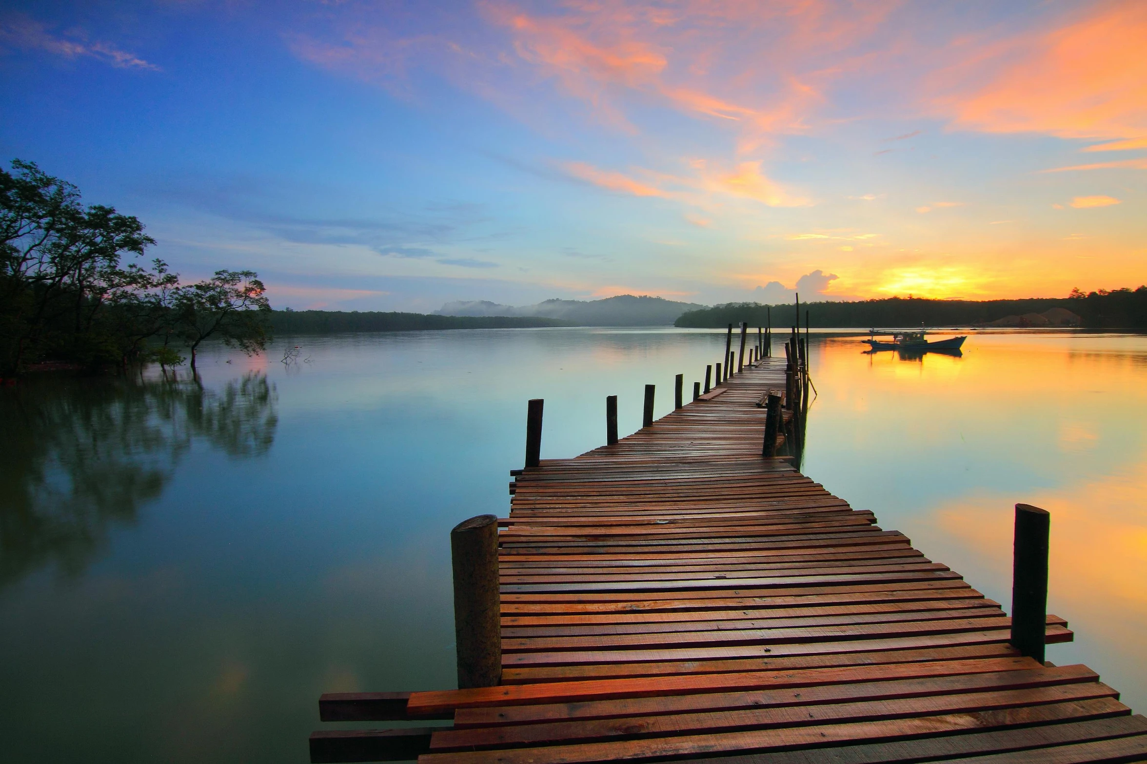 a dock in the middle of a lake at sunset, inspired by Edwin Deakin, pexels contest winner, romanticism, tropical climate, multicoloured, mangrove trees, serene landscape