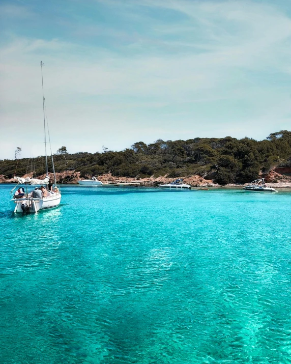 a couple of boats that are in the water, a photo, pexels contest winner, ibiza, iridescent shimmering pools, thumbnail, archipelago