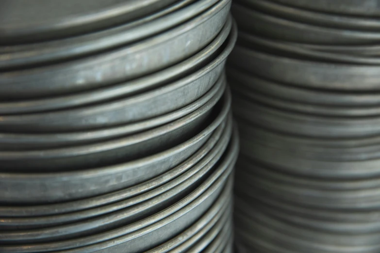 a stack of metal plates stacked on top of each other, by Alison Watt, unsplash, plasticien, photorealistic detail, cast iron material, 84mm), high angle close up shot