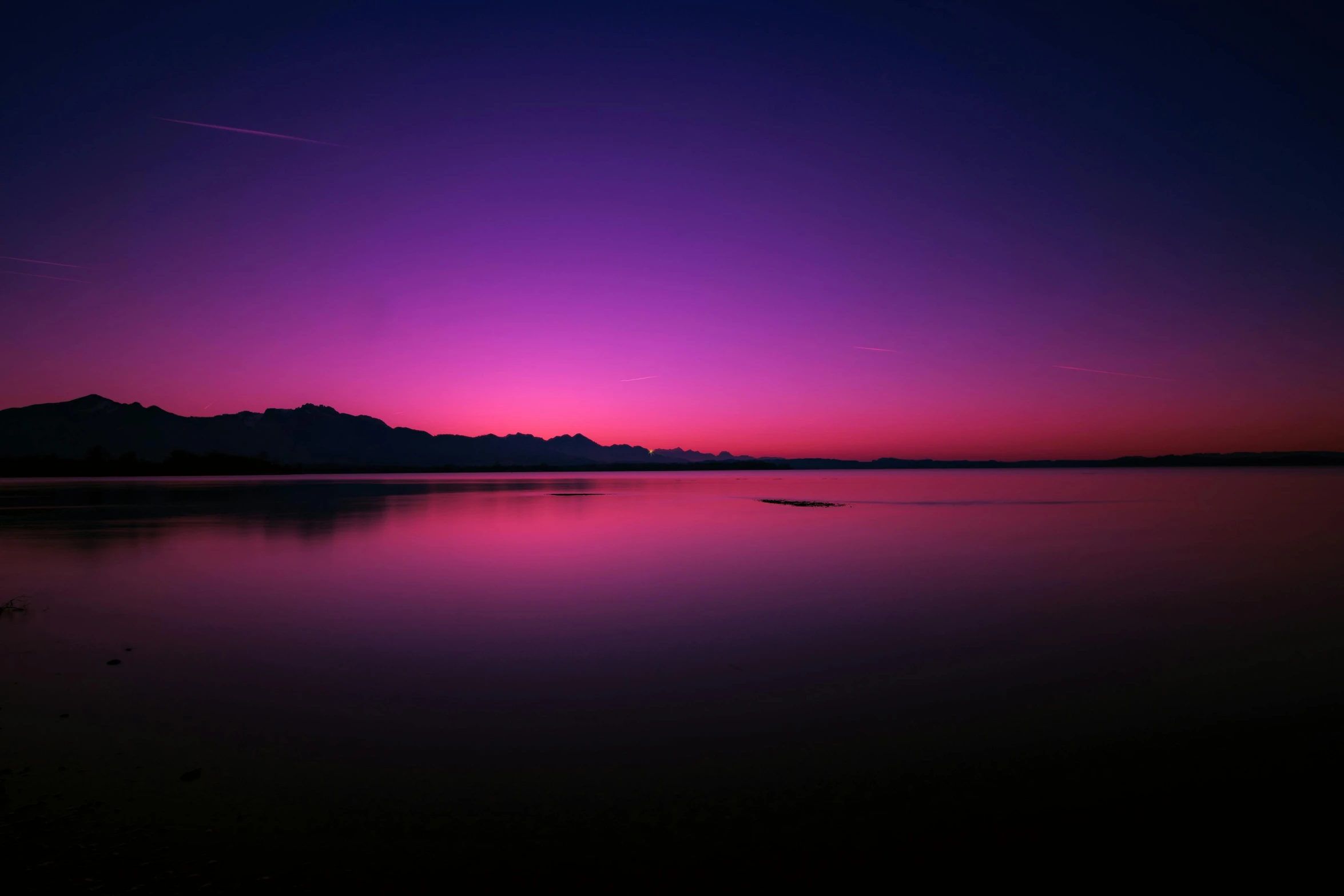 a large body of water with mountains in the background, pexels contest winner, romanticism, gradient dark purple, pink light, nightfall, complementary colours