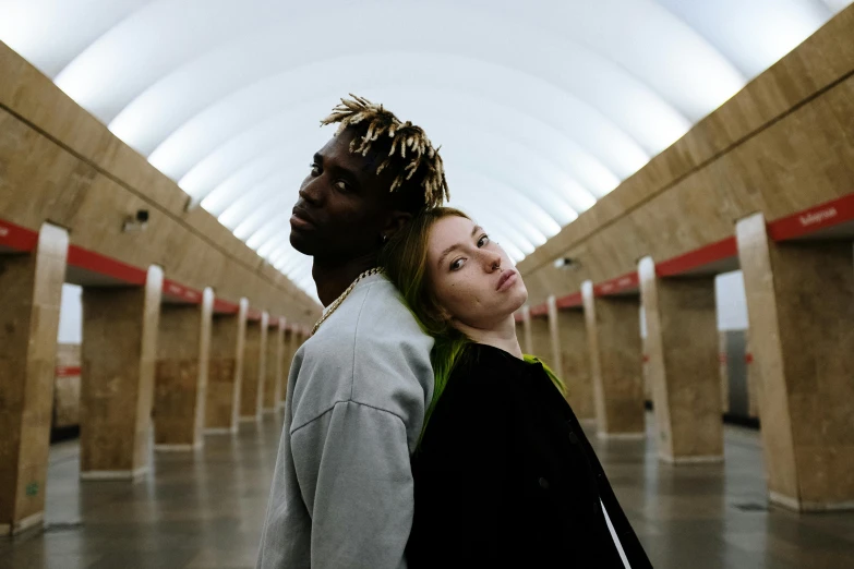 a man and a woman standing next to each other, trending on pexels, realism, young thug, moscow metro, bleached, promotional image