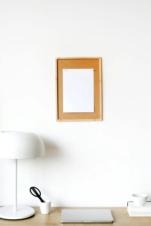 a laptop computer sitting on top of a wooden desk, a minimalist painting, by Matthias Stom, postminimalism, card frame, white background wall, vertical movie frame, white paper