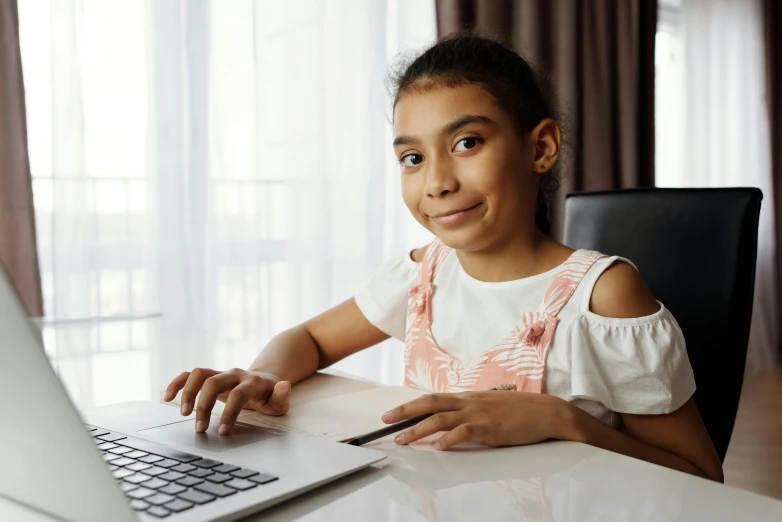 a little girl sitting in front of a laptop computer, pexels contest winner, an olive skinned, pokimane, school curriculum expert, thumbnail