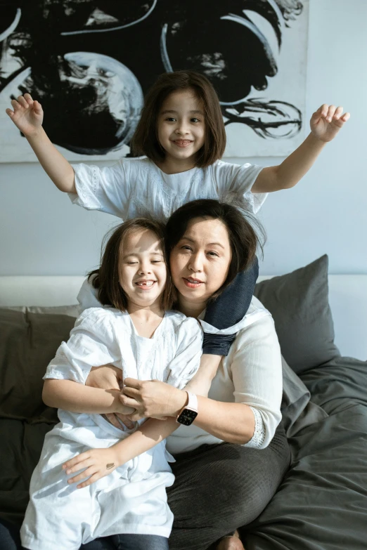 a woman and two children sitting on a bed, inspired by Ni Duan, pexels contest winner, incoherents, arms spread wide, portrait of modern darna, 15081959 21121991 01012000 4k, bangkok