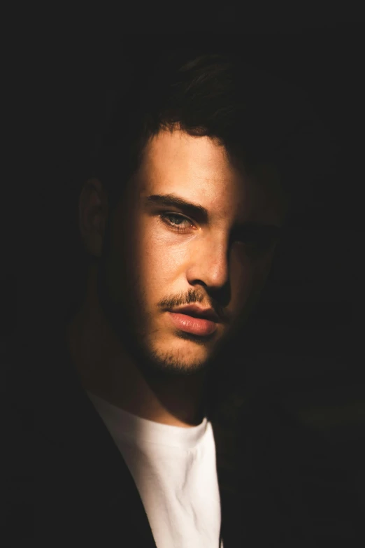 a close up of a person wearing a suit and tie, an album cover, inspired by Carlo Mense, shaven stubble, post malone, dramatic lighting man, pouty