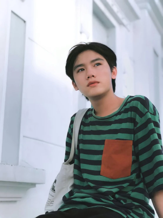 a young man sitting on the steps of a building, inspired by Yanagawa Nobusada, unsplash, short green bobcut, wearing stripe shirt, ✨🕌🌙, henry ascensio