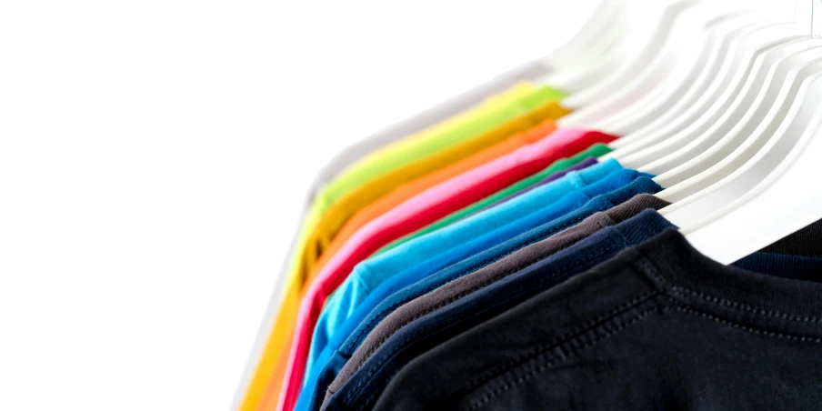 a row of t - shirts hanging on a clothes rack, vibrant hues, advanced technology, zoomed in, breeches