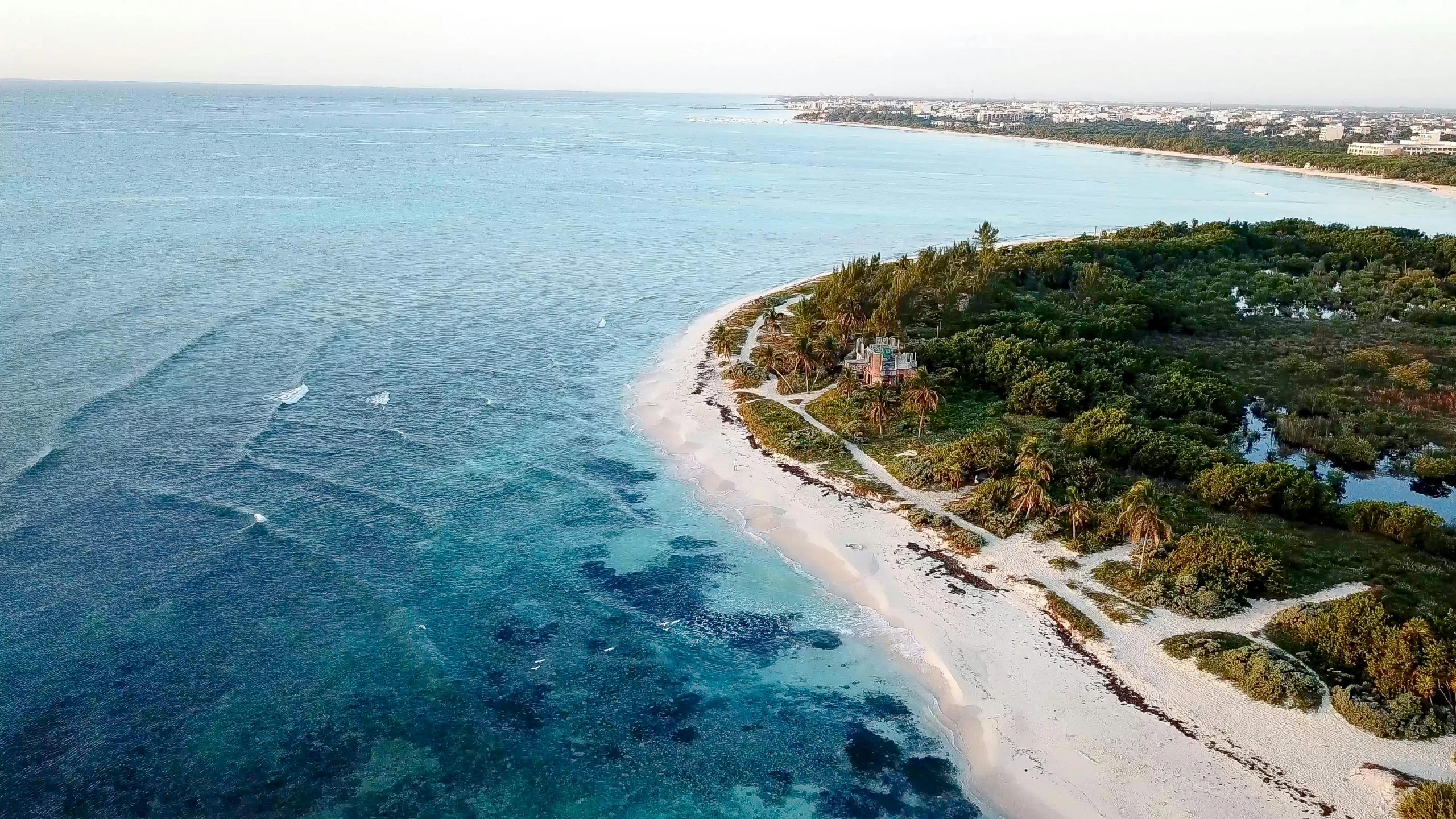 an island in the middle of a body of water, beach on the outer rim, beachfront mansion, guide, highlights