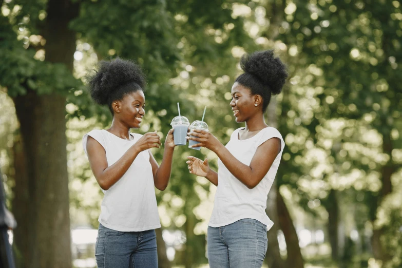 a couple of women standing next to each other, by Everett Warner, pexels, happening, moringa juice, black teenage girl, drink milkshakes together, avatar image