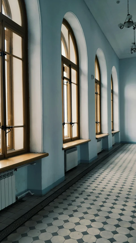 a room with several windows and a checkered floor, inspired by Constantin Hansen, unsplash contest winner, courtroom the bench, pointed arches, anna nikonova, long hallway