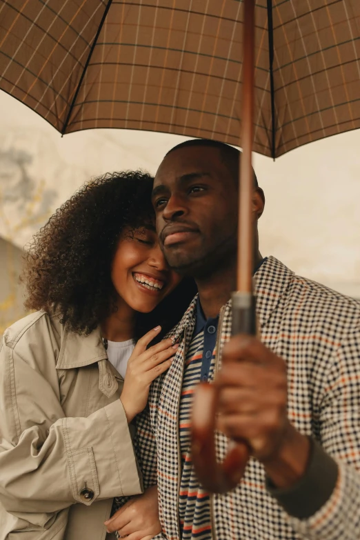 a man and woman standing under an umbrella, trending on pexels, renaissance, with brown skin, wholesome, romantic lead, happy girl