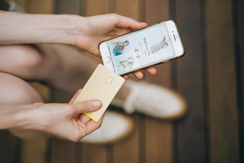 a close up of a person holding a cell phone, whole card, square, gold, thumbnail