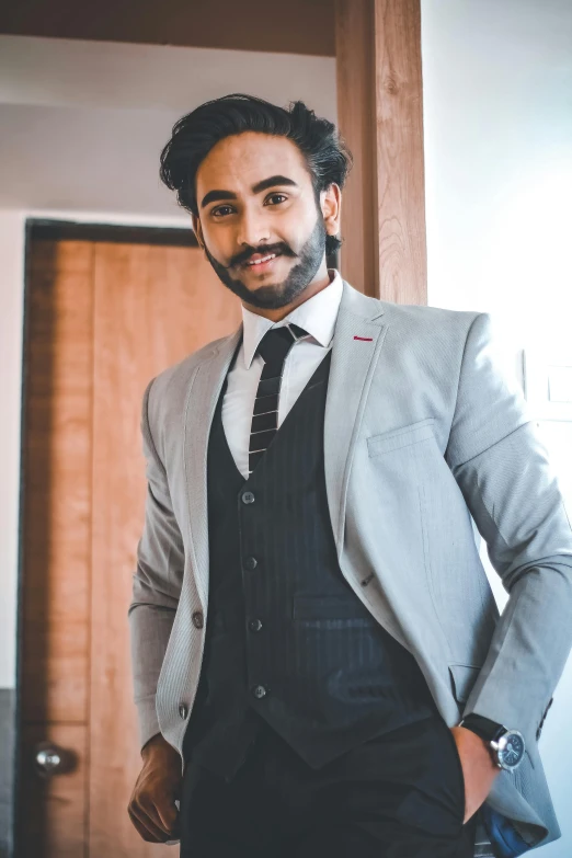 a man in a suit and tie posing for a picture, a colorized photo, inspired by Manjit Bawa, pexels contest winner, androgynous person, wearing casual clothing, wearing a vest, candid shot