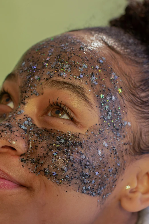 a close up of a woman with glitter on her face, black slime, face mask, with textured hair and skin, lush