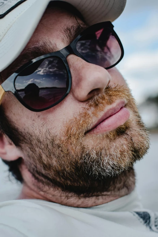 a close up of a person wearing sunglasses and a hat, a picture, reddish beard, 2019 trending photo, paul davey, rectangle