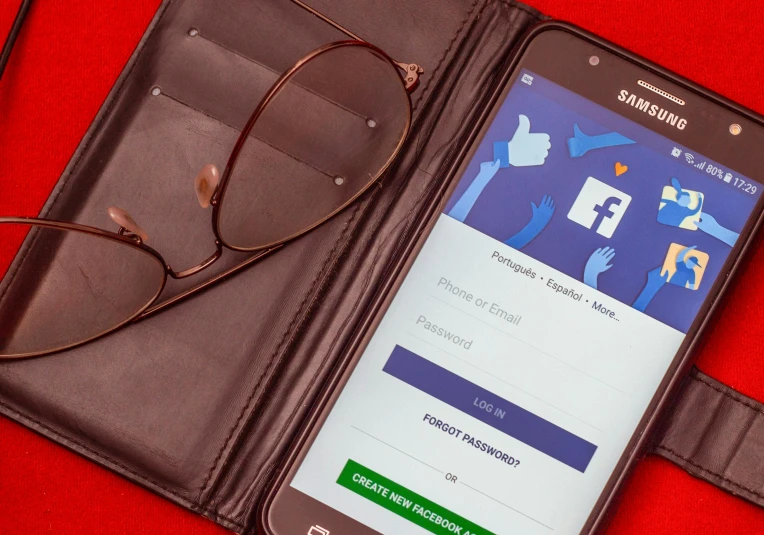 a cell phone sitting on top of a wallet next to a pair of glasses, trending on pexels, tachisme, zuckerberg, striking pose, facebook profile picture, 1 4 5 0