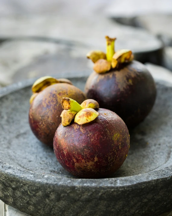 a plate that has some kind of fruit on it, inspired by Jane Nasmyth, unsplash, hurufiyya, mangosteen, south east asian with round face, pot, slate