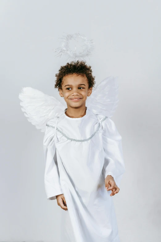 a little boy dressed up as an angel, inspired by Marie Angel, white and silver, product shot, 2 angels, basic