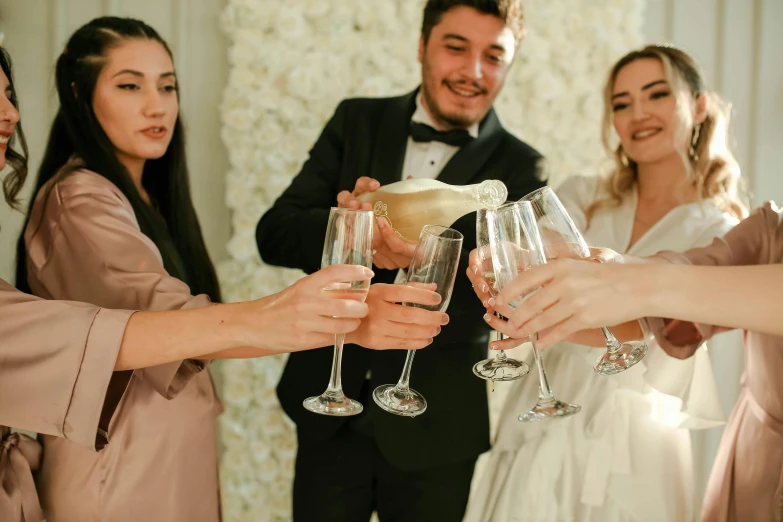 a group of people standing next to each other holding wine glasses, profile image, wedding, champagne on the table, multiple stories