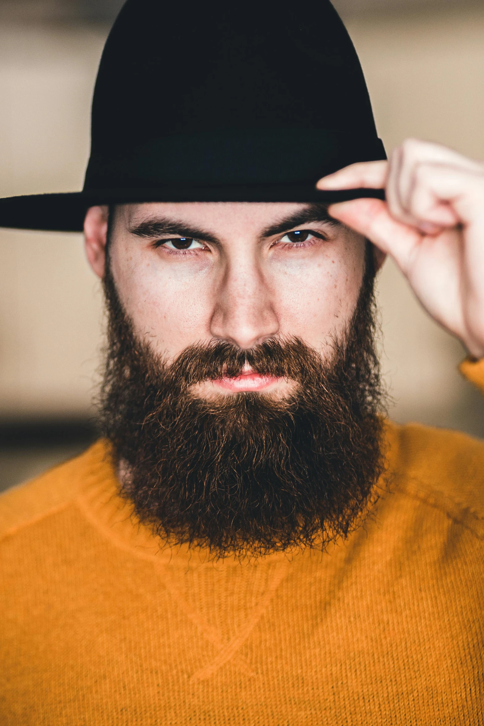 a man with a beard wearing a black hat, trending on pexels, hairy orange body, symmetrical long head, australian, vanilla