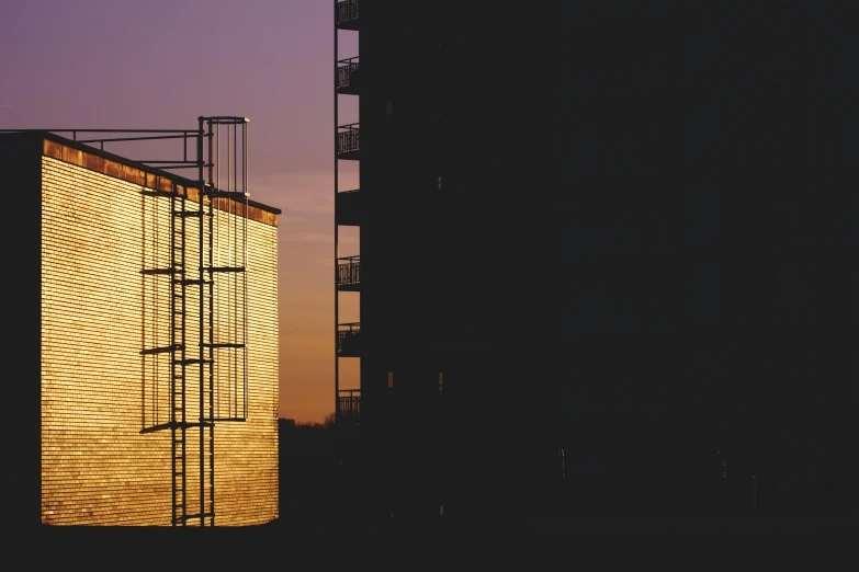 a couple of tall buildings sitting next to each other, an album cover, inspired by Elsa Bleda, unsplash, brutalism, golden hour closeup photo, 15081959 21121991 01012000 4k, scrapyard architecture, backlit glow