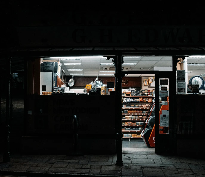 a store front that is lit up at night, an album cover, pexels contest winner, convenience store, dark shadowy surroundings, weapon shop interior, elliot alderson