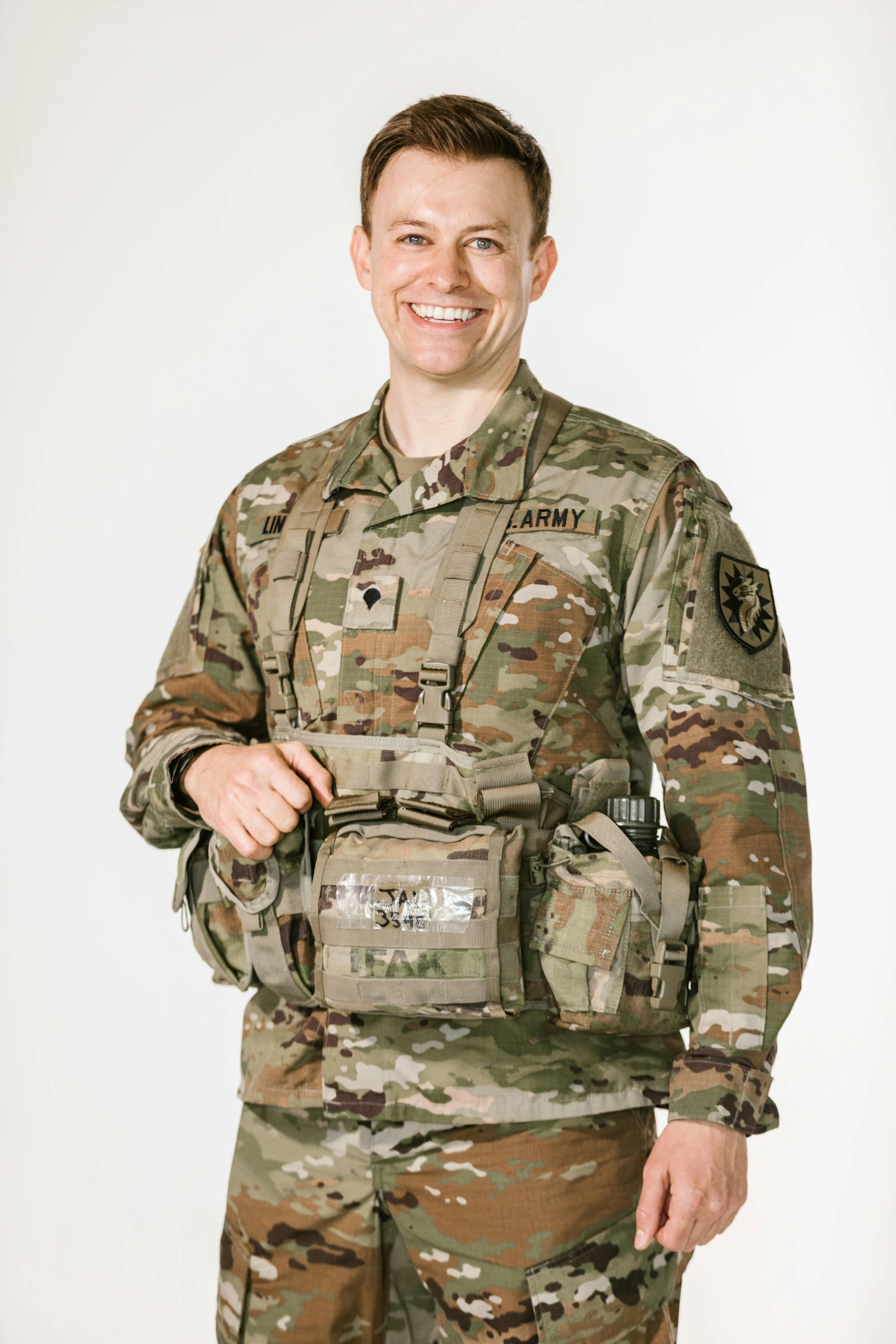 a man in a military uniform posing for a picture, wearing adventuring gear, adafruit, with two front pockets, on clear background