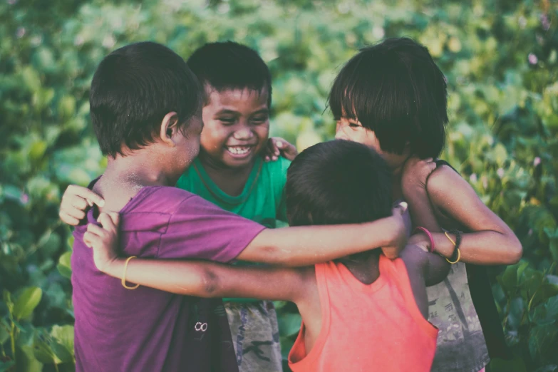 a group of children standing next to each other, pexels contest winner, happening, hugging and cradling, south east asian with round face, coloured, playing