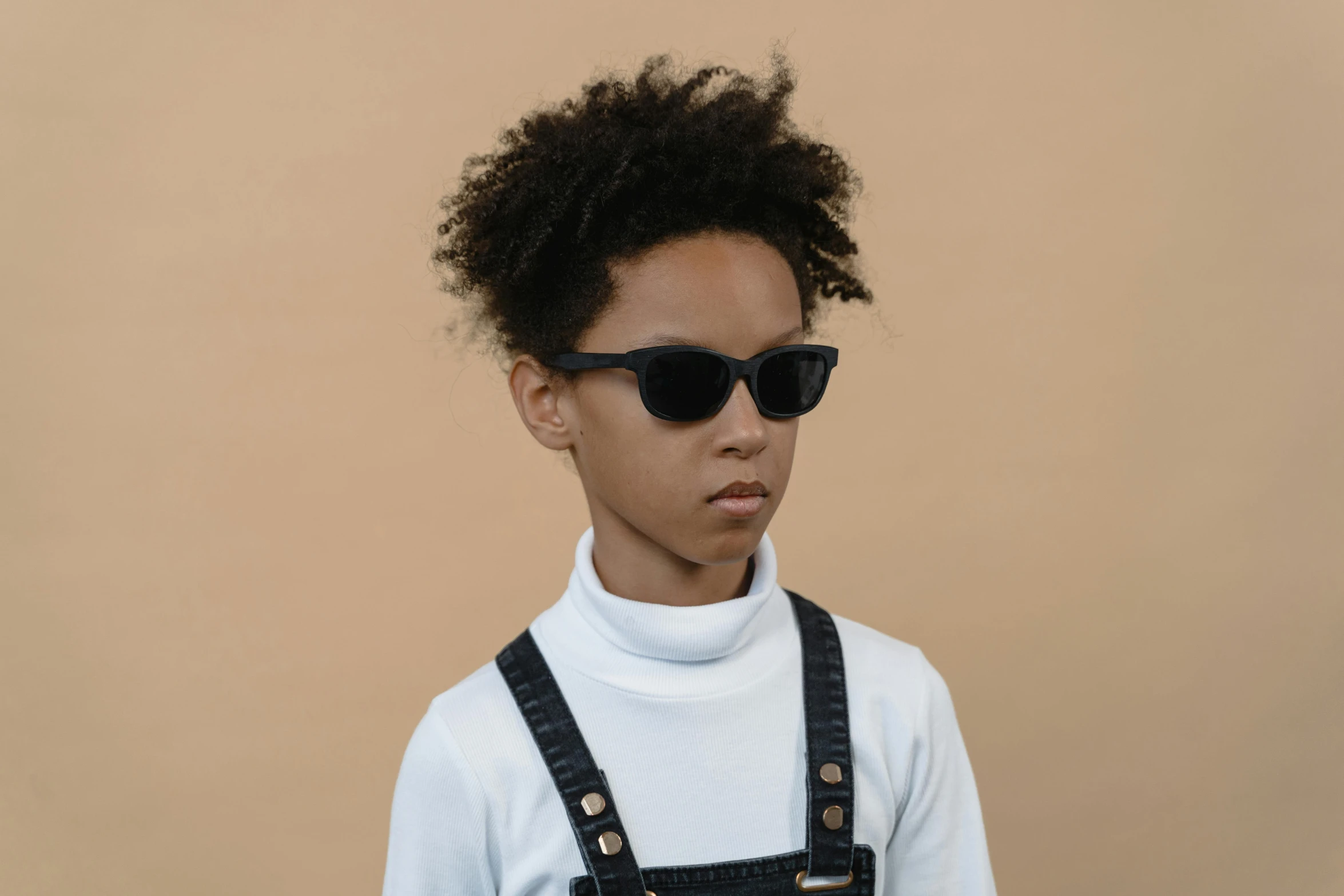 a young boy wearing sunglasses and overalls, pexels contest winner, bauhaus, black turtleneck, black girl, detailed product image, high resolution product photo